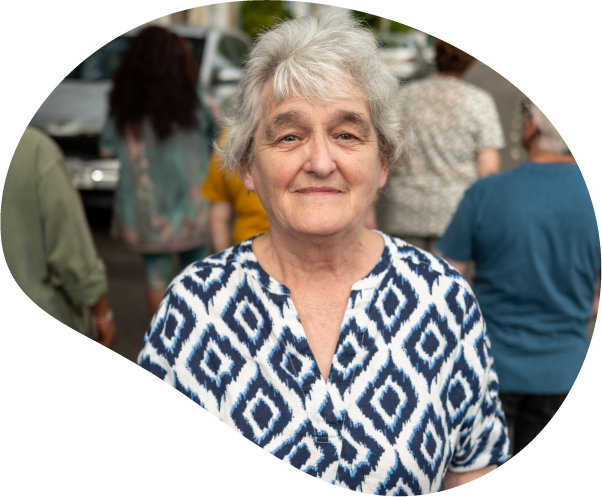 A photo of a lady with white hair looking solemnly forward