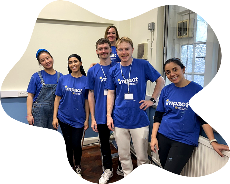 Warner Bros. Discovery staff members smiling for a photo after volunteering to paint a group room in one of Waythrough's London services