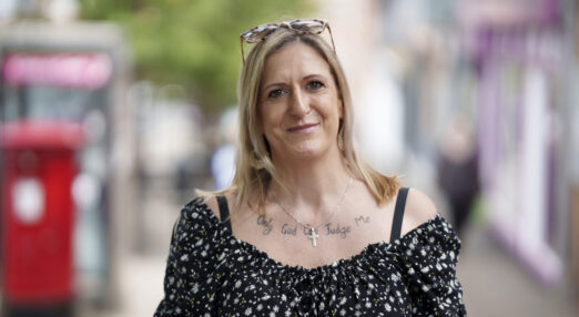 A photograph of Melissa, who is a member of Waythrough's Life Experience Council. She has blonde hair, is wearing a patterned blouse, and is smiling straight at the camera.