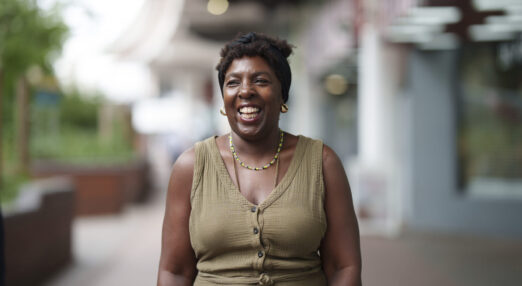 A photograph of Pauline, a Peer Mentor Volunteer at Enable. She is looking slightly to the side of the camera and smiling.